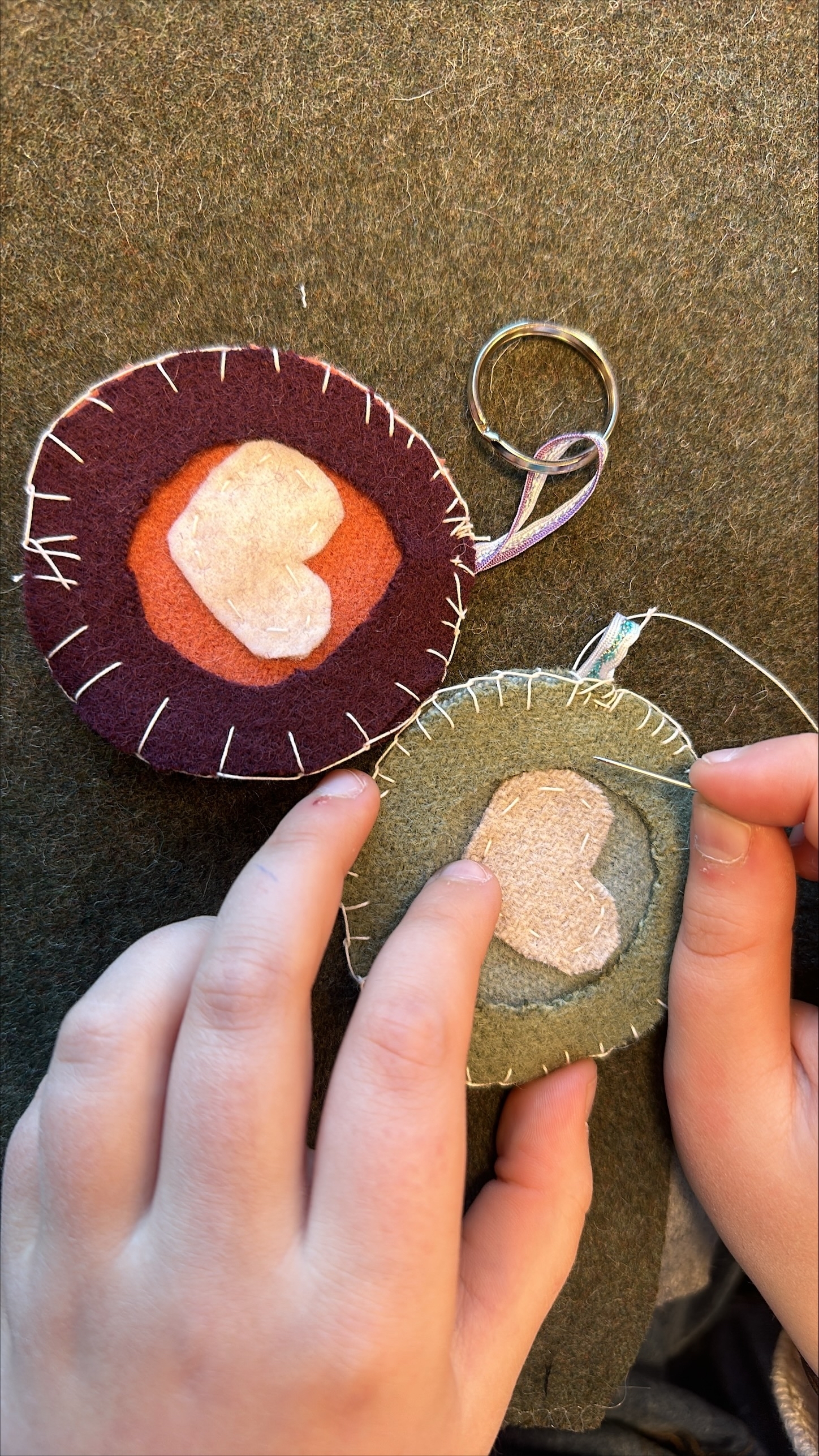 et par hender som syr en hjerteformet pynt